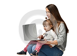 Family mother and child daughter at home with a laptop