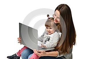 Family mother and child daughter at home with a laptop