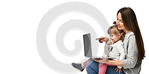 Family mother and child daughter at home with a laptop