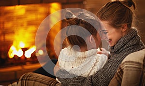 Family mother and child hugs and laughing on winter evening by f