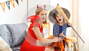 Family mother and child daughter getting ready for halloween,