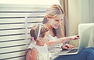 Family mother and child with laptop