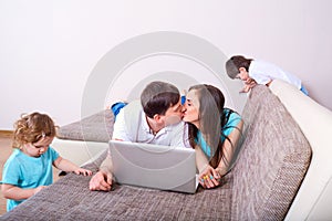 Family of mother, father ,daughter and boy, parent kissing ,kid