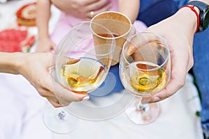 Family mother, father and doughter clinking with glasses of wine