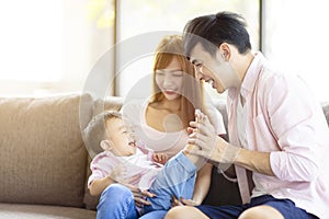 Family mother and father playing with baby at home