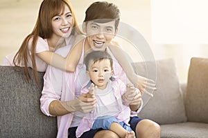 family mother and father playing with baby at home