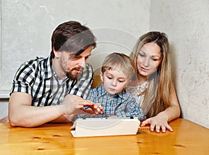 Family mother, father and son looking at tablet pc