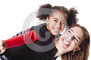 A family mother with girl child posing on a white background studio