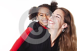 A family mother with girl child posing on a white background studio