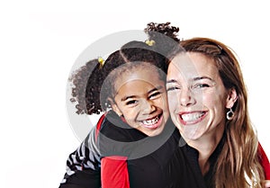 A family mother with girl child posing on a white background studio