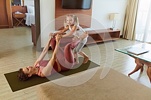 Family. Mother And Kid Practicing Partner Yoga At Home. Young Woman And Child Exercising Together. Sporty Daughter And Parent