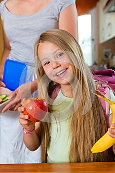 Family - mother making breakfast for school