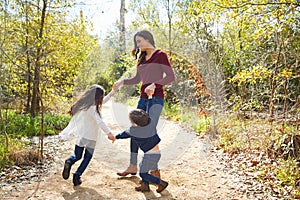 Family mother son and daughter turning circles