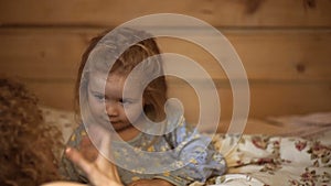 Family mother and son read a book in the evening at home. Son and mother are happy together. Mother telling story to son