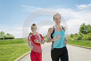 Family, mother and son are running or jogging for sport outdoors