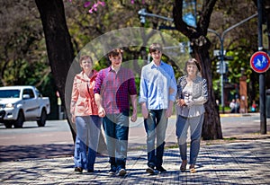 Family mother, sons and grandmother in the park