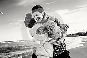 family mother with three children kids hugging smiling laughing on ocean sea beach