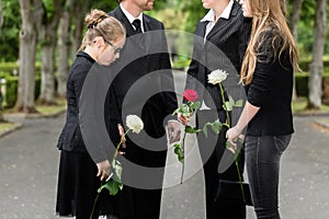 Family mourning on funeral at cemetery