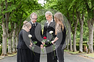 Family mourning on funeral at cemetery photo