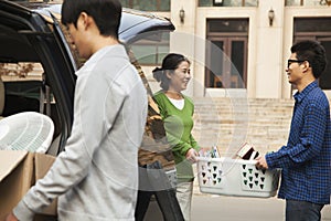 Family moving their son into dormitory on college campus