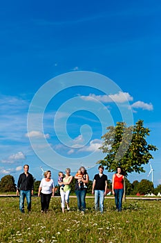 Family and multi-generation - fun on meadow in summer