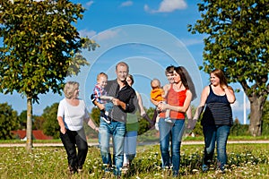 Family and multi-generation - fun on meadow in summer