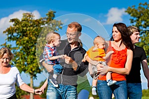 Family and multi-generation - fun on meadow in summer