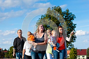 Family and multi-generation - fun on meadow in summer