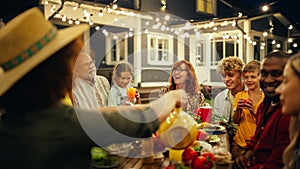 Family and Multicultural Friends Celebrating Outside at Home in the Evening. Group of Children