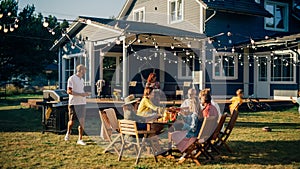 Family and Multiethnic Diverse Friends Gathering Together at a Garden Table. People Cooking Meat on