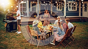 Family and Multiethnic Diverse Friends Gathering Together at a Garden Table. People Cooking Meat on