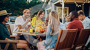 Family and Multiethnic Diverse Friends Gathering Together at a Garden Table. People Eating Grilled