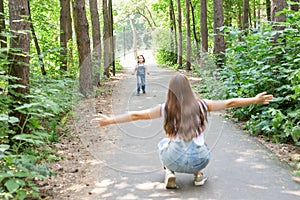 Family and nature concept - Attractive young woman have fun with her little daughter in the park