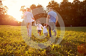 Family in nature together, back view