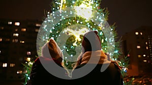 Family near the Christmas tree.