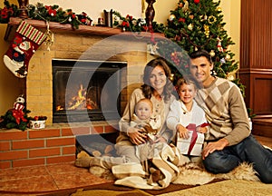 Family near fireplace in Christmas house