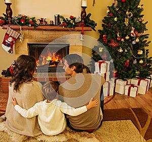 Family near fireplace in Christmas house