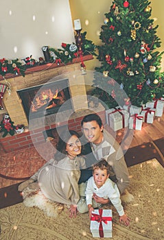 Family near fireplace in decorated house interior