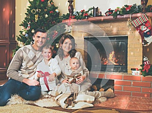 Family near fireplace in decorated house interior