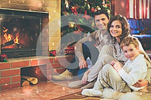 Family near fireplace in decorated house interior