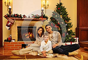 Family near fireplace in house interior