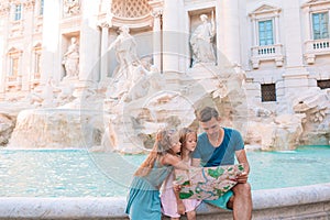 Family near Fontana di Trevi, Rome, Italy. Happy father and kids enjoy italian vacation holiday in Europe.