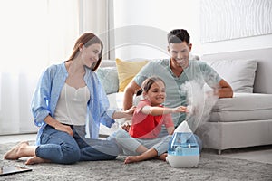 Family near modern air humidifier
