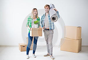 Family, new apartment and relocation concept - Young couple moving in new house