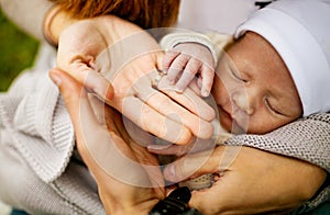 Family and new born baby, parents holding newborn child.