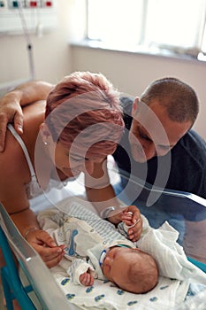 Family with newborn baby in postnatal hospital