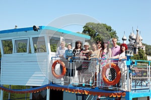 Family of nine people walking on pleasure craft