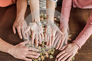 Family with one child playing with puzzles on table