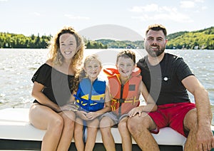 Family out boating together having fun on vacancy