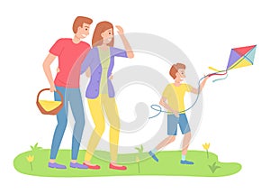 Family outdoor recreational activities, parents looking at son with flying kite, recreation time